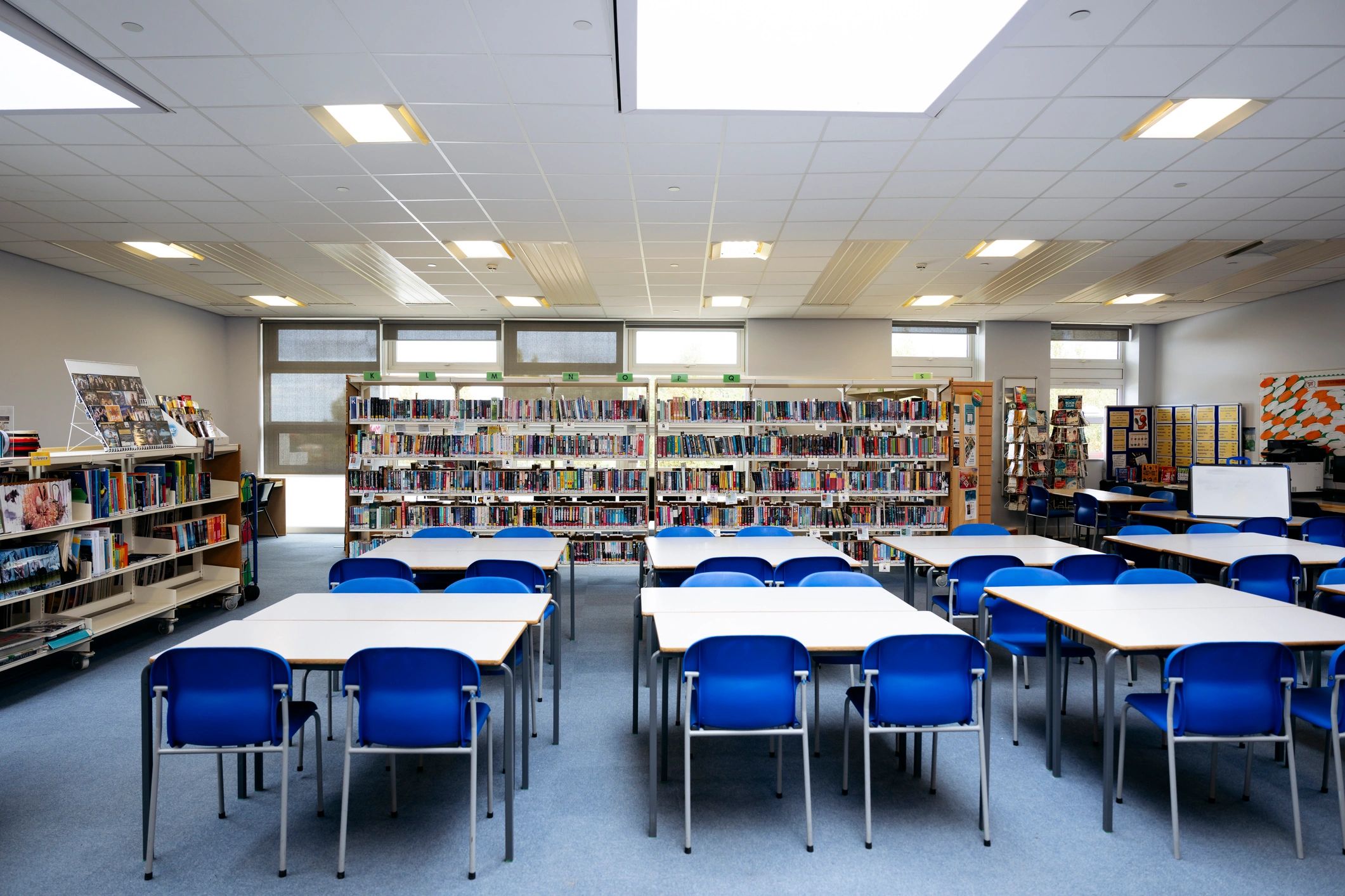 Library reading room with shelves, desks, and chairs